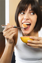 man eating grapefruit